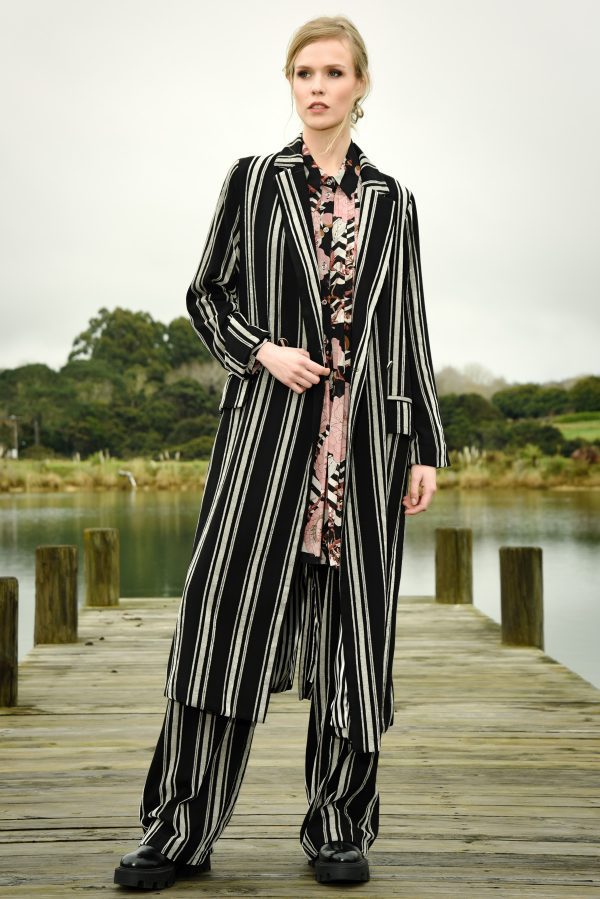 The Long Night Coat has a double-breasted closure and flap pockets you’ll have a timeless piece that will elevate any winter look.