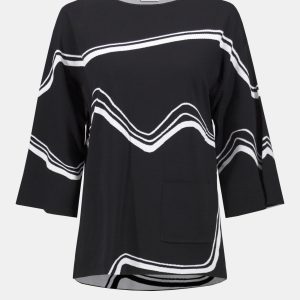 This jacquard sweater knit pullover features an alluring abstract design, a flattering boat neck and graceful bell sleeves.