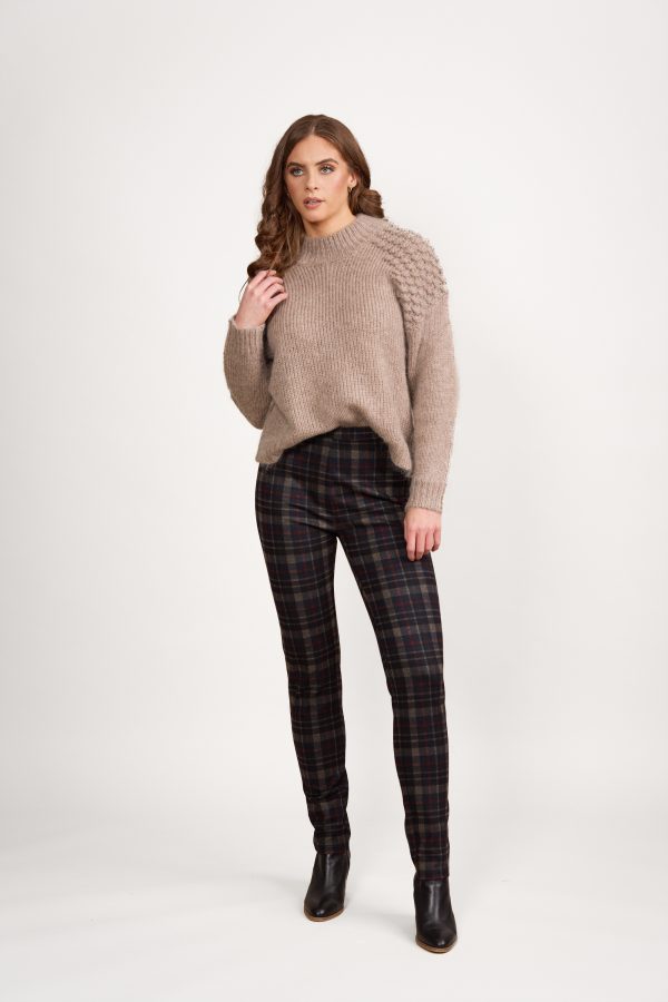 The Vassalli Skinny Leg Printed Pull-On Ponti Pant is a mid-weight stretchy pant featuring a black, red, and beige plaid design.