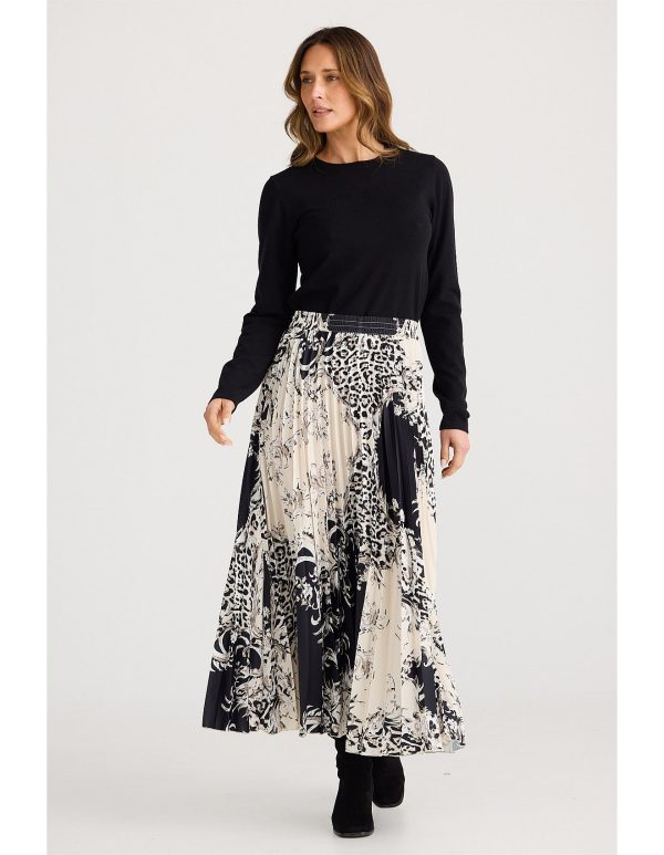 The Alias Pleated Skirt blends contemporary elegance with classic appeal. Its permanently pleated design flows beautifully with every movement.